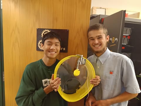 Two students holding the finished drum