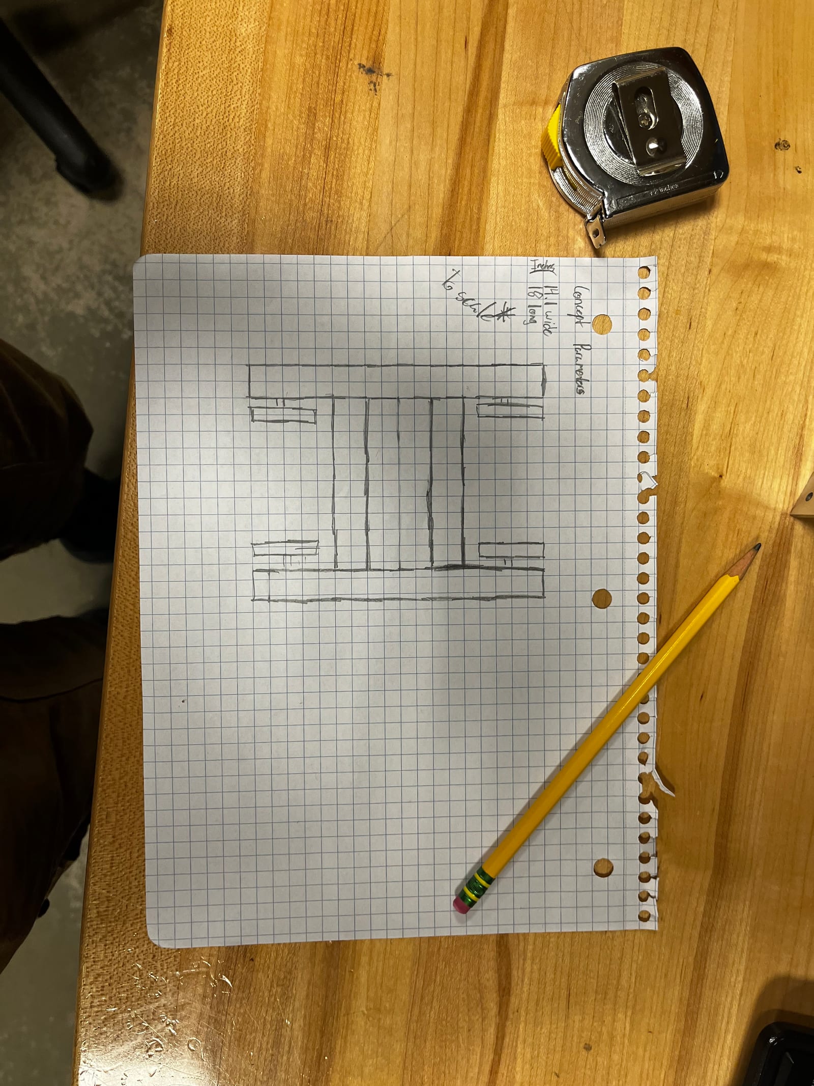 Graph-paper sketch of the chassis with a tape measure and pencil